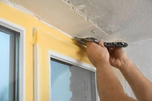 bigstock-Man-Plastering-Window-Area-Wit-344408680-jpg.webp