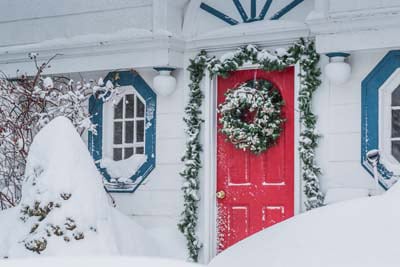 An Exterior Door Decorated For Christmas in Winter